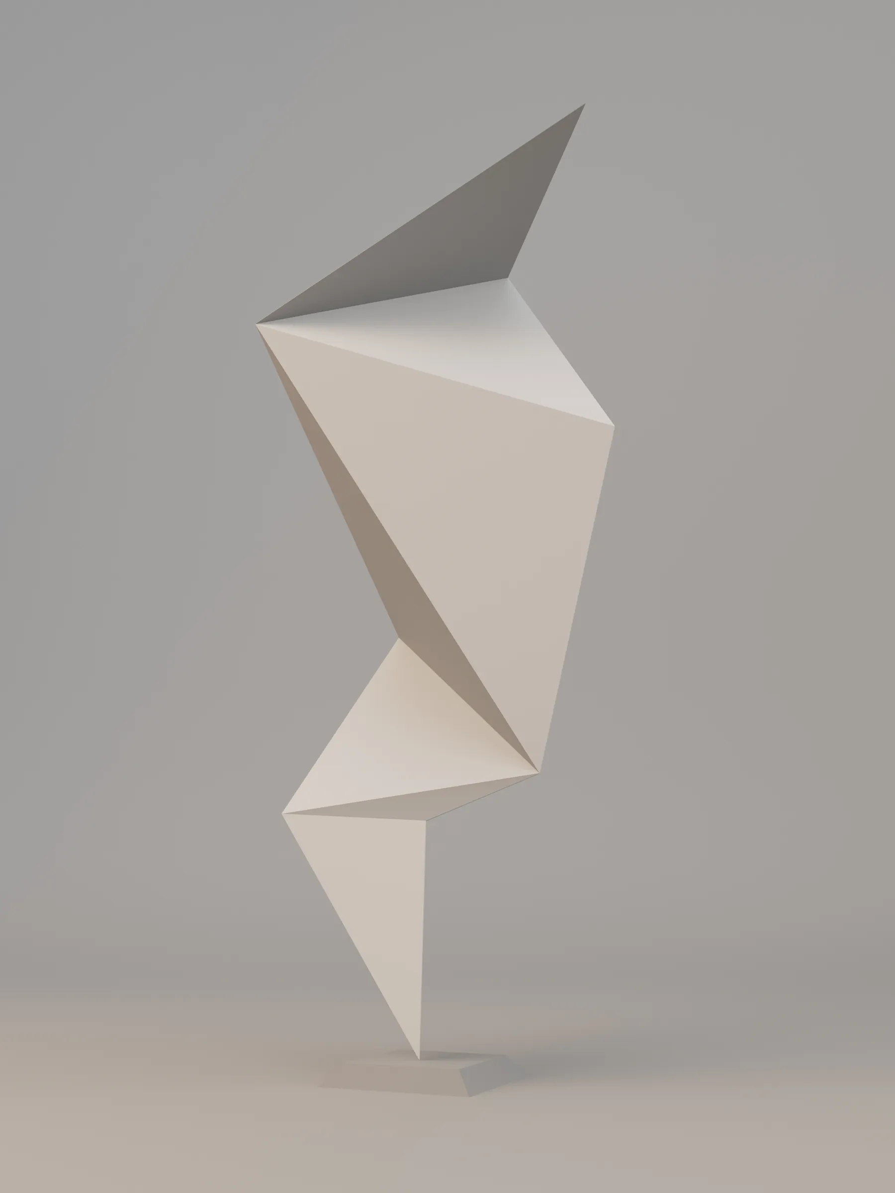 A folded geometric paper form balanced vertically